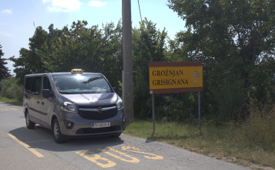 Taxi vehicle with Grožnjan backdrop - visit the artistic town comfortably